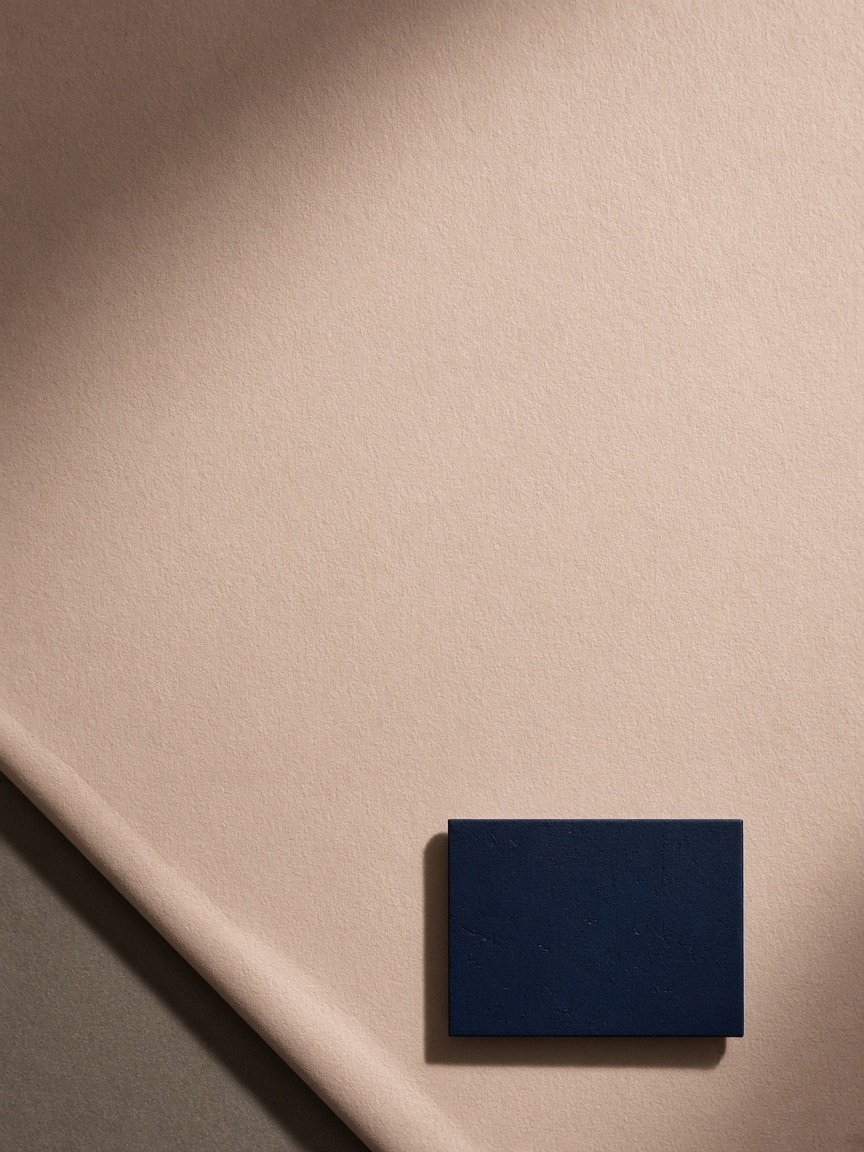 Pale sheet with a small navy plate in the lower corner.